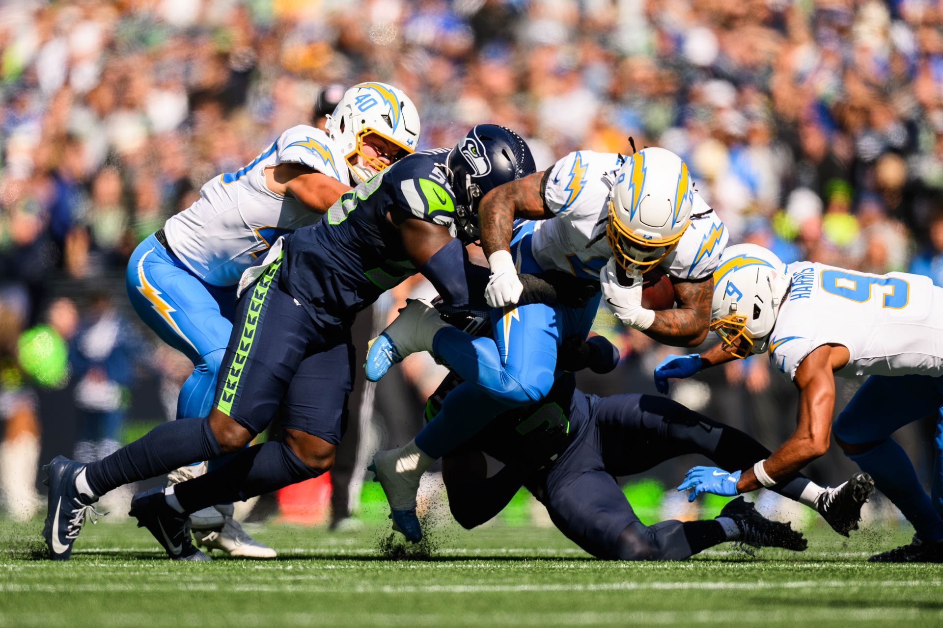 Omarion Hampton dives with the ball in NFL game at Lumen Field