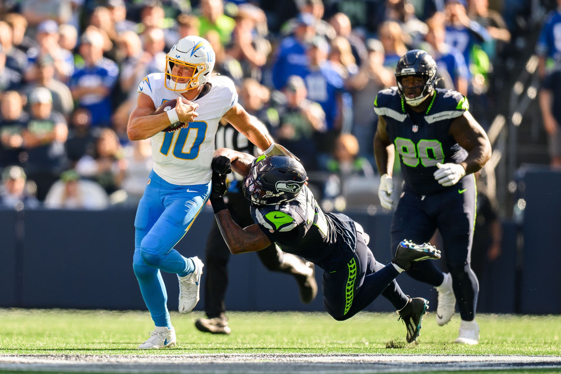 Justin Herbert runs the ball in NFL game against Seahawks