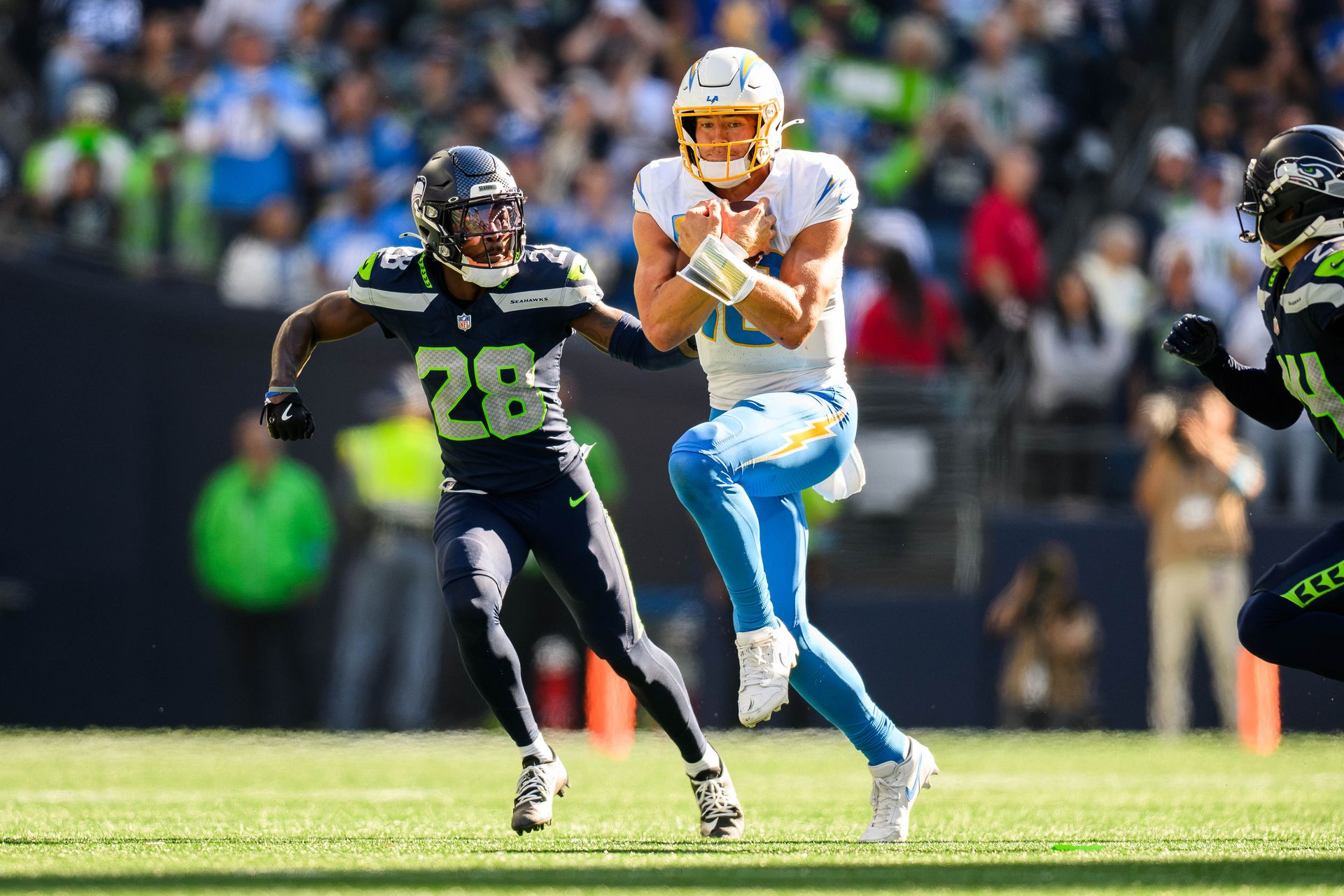 Justin Herbert evades Seahawks defense during NFL game