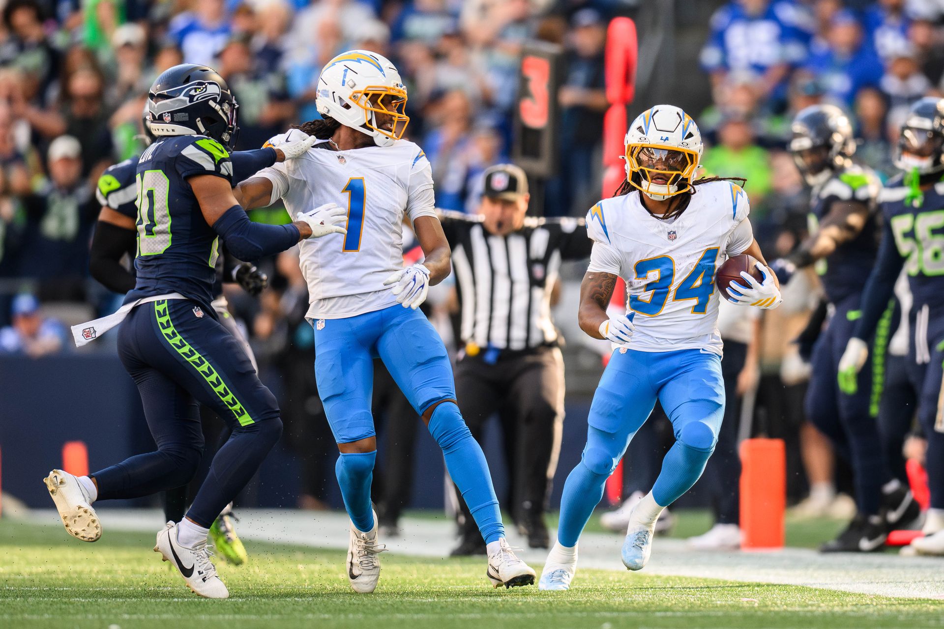 Keaton Mitchell runs the ball in NFL game at Lumen Field