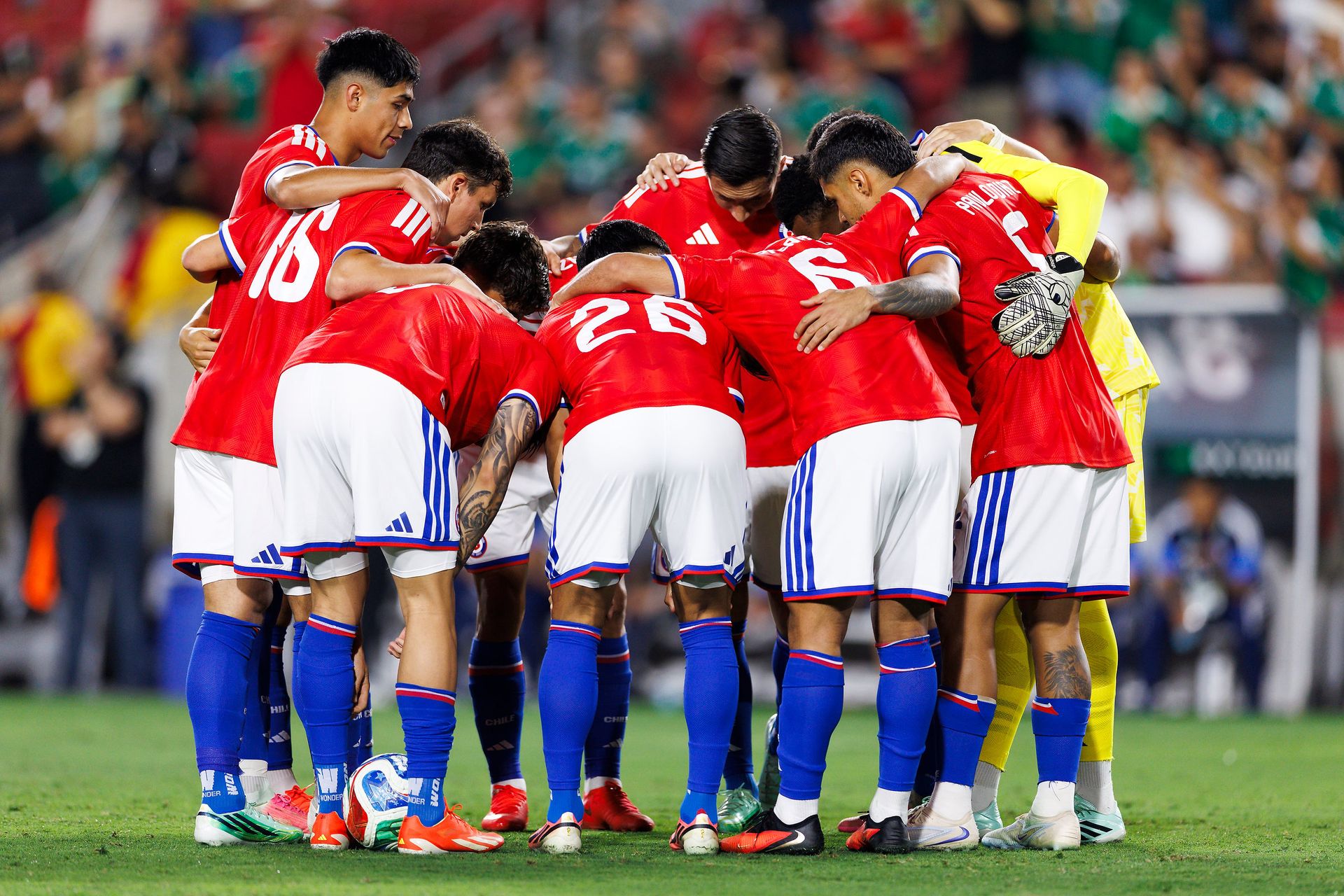 Chile team huddle at Los Angeles Memorial Coliseum