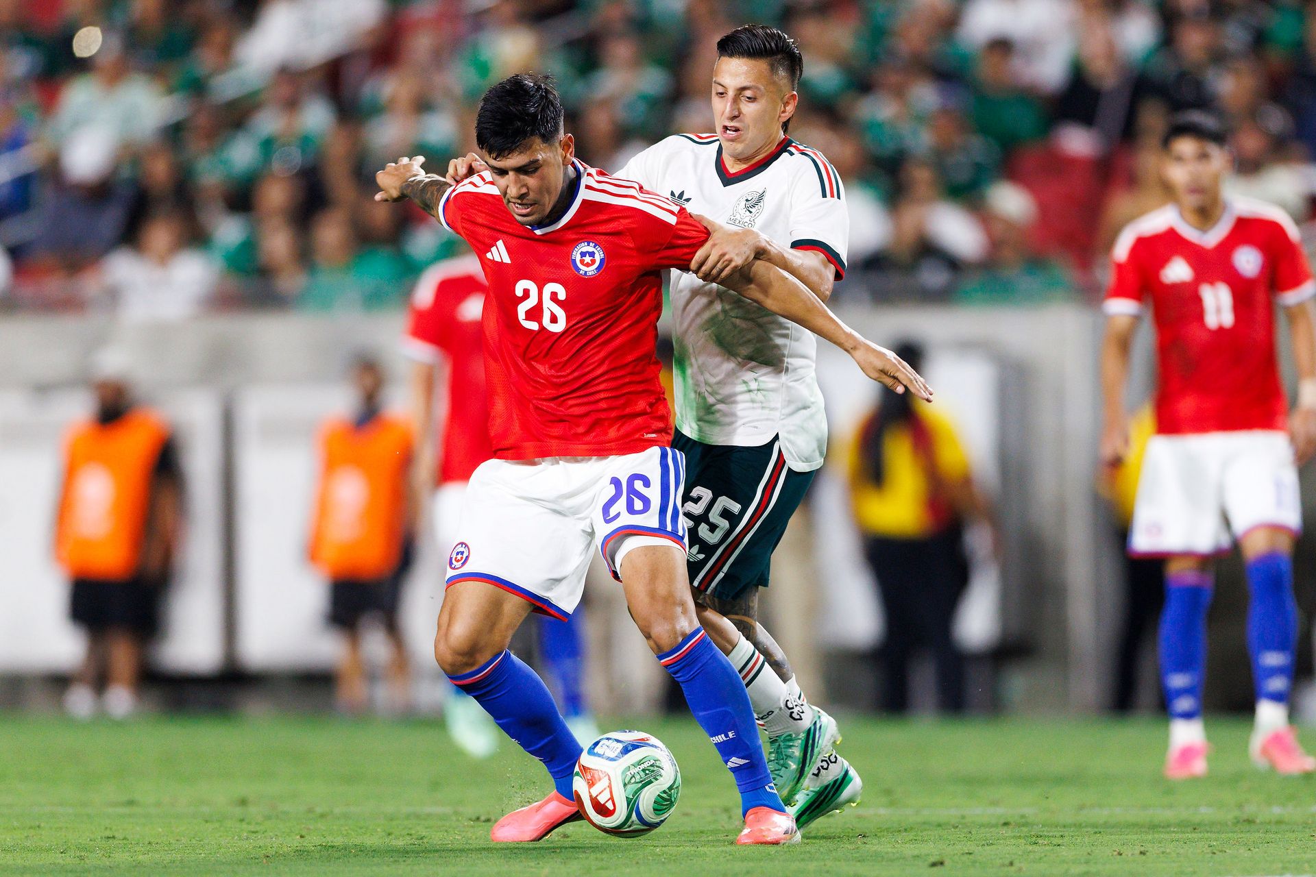 Diego Ulloa fights for the ball against Mexico