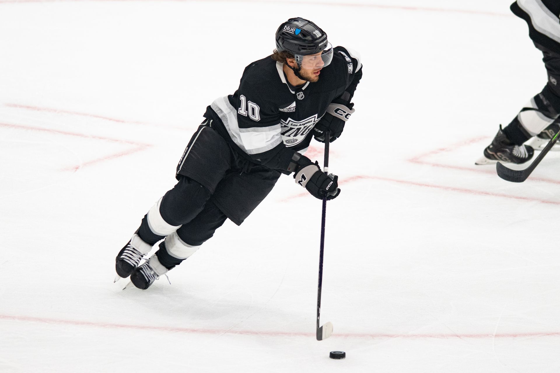 Corey Perry skates with the puck in NHL action against Panthers.