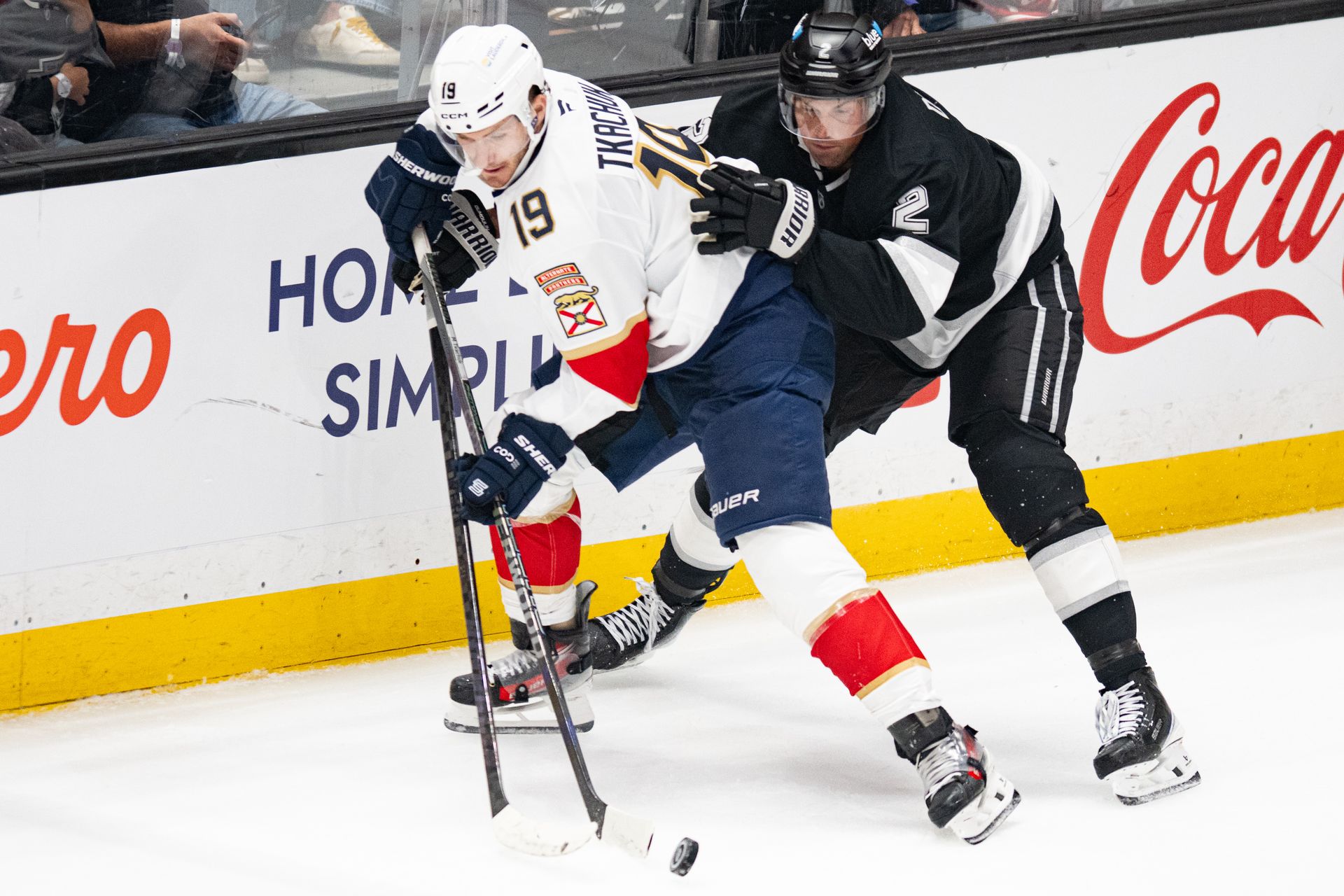 Brian Dumoulin in a puck battle with Matthew Tkachuk.
