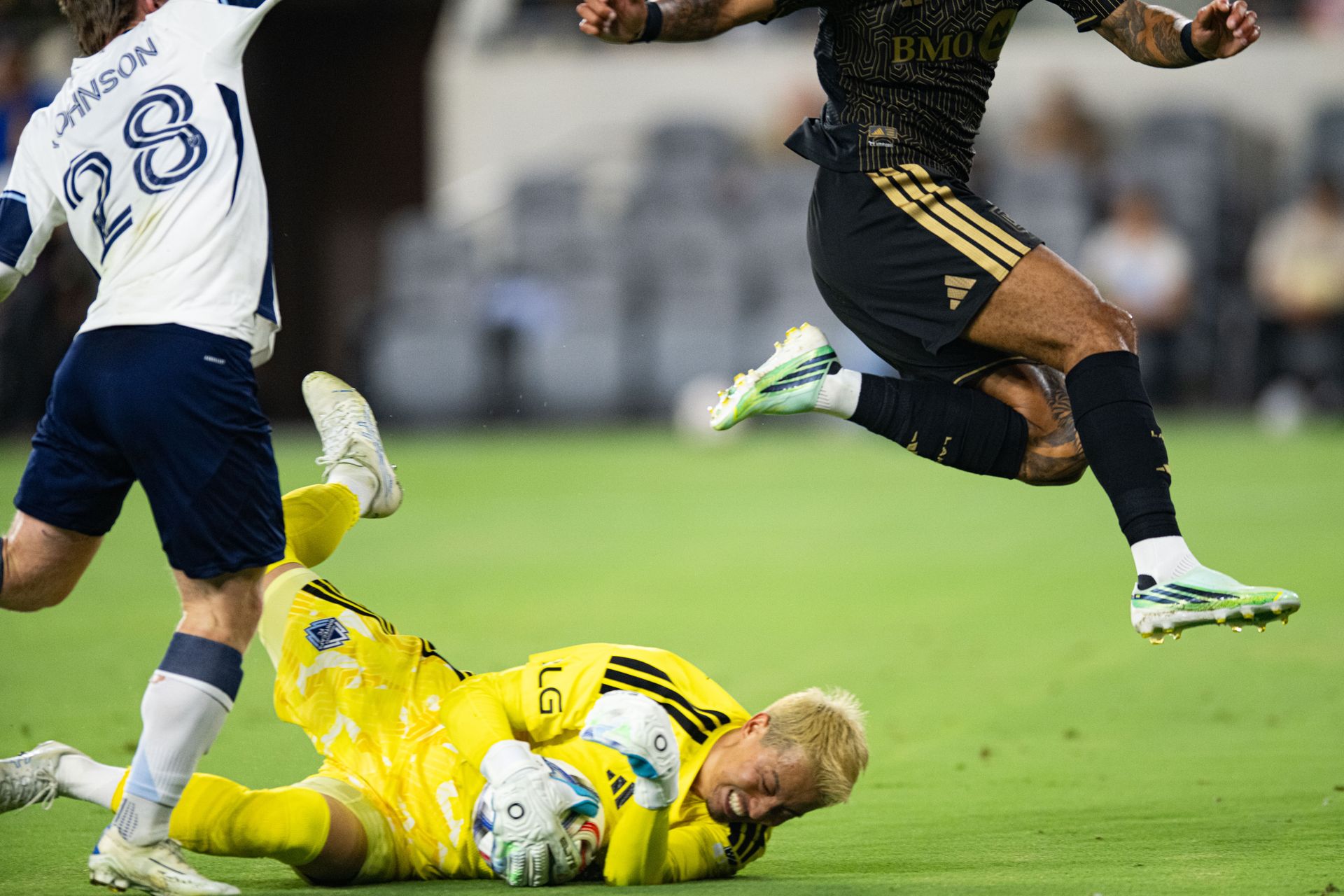 Yohei Takaoka (1) makes a diving save for the Whitecaps
