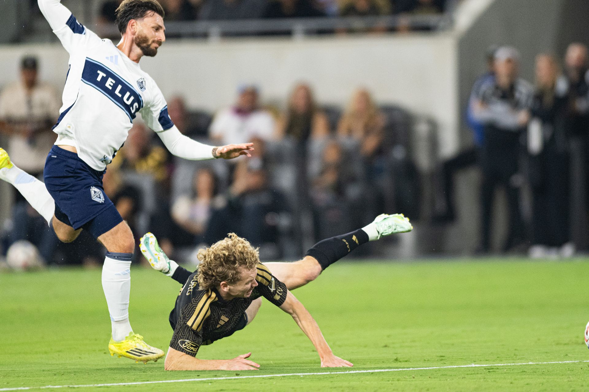 Jacob Shaffelburg (18) gets tackled in the match