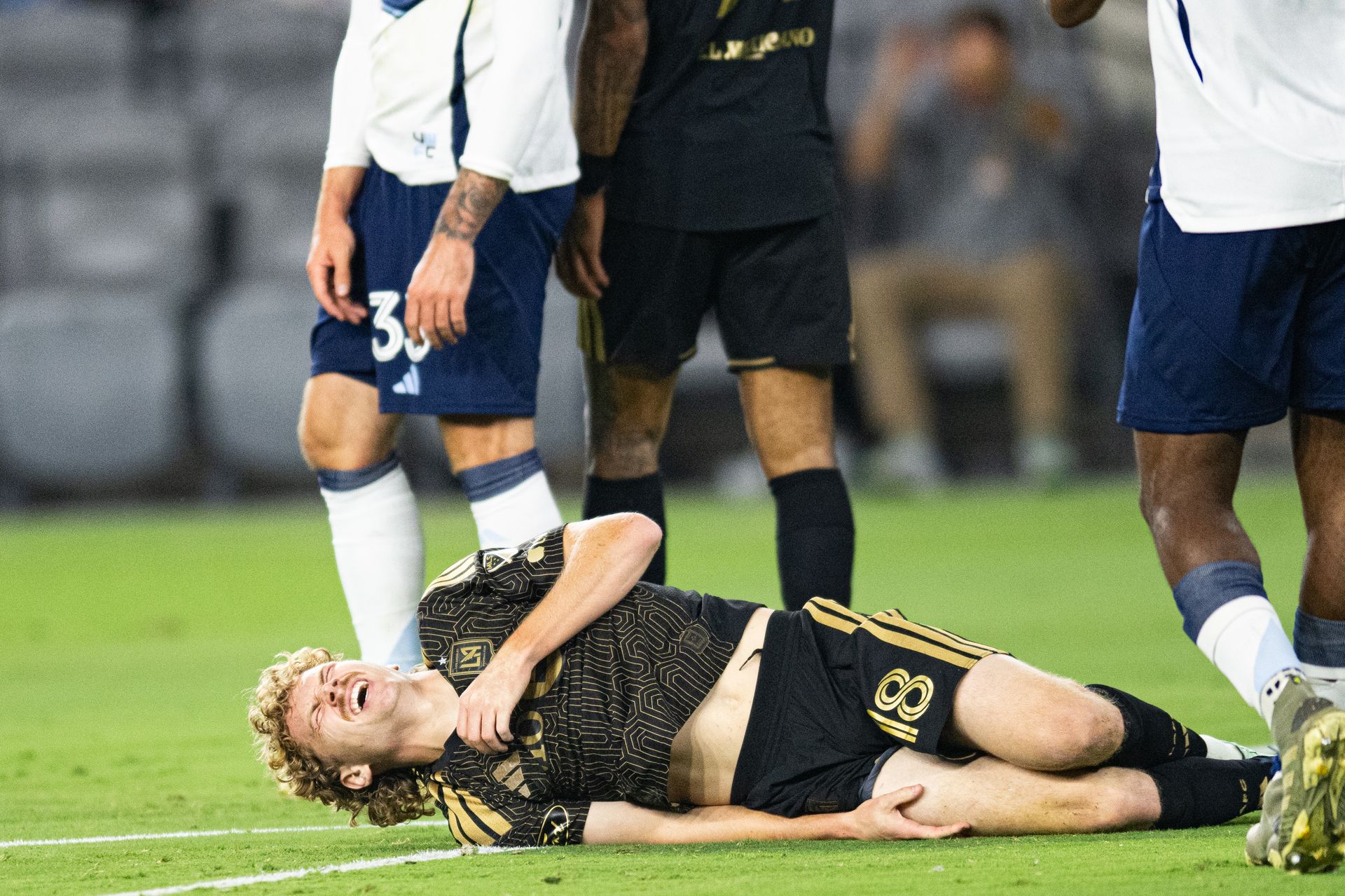 Jacob Shaffelburg (18) in pain after a tackle