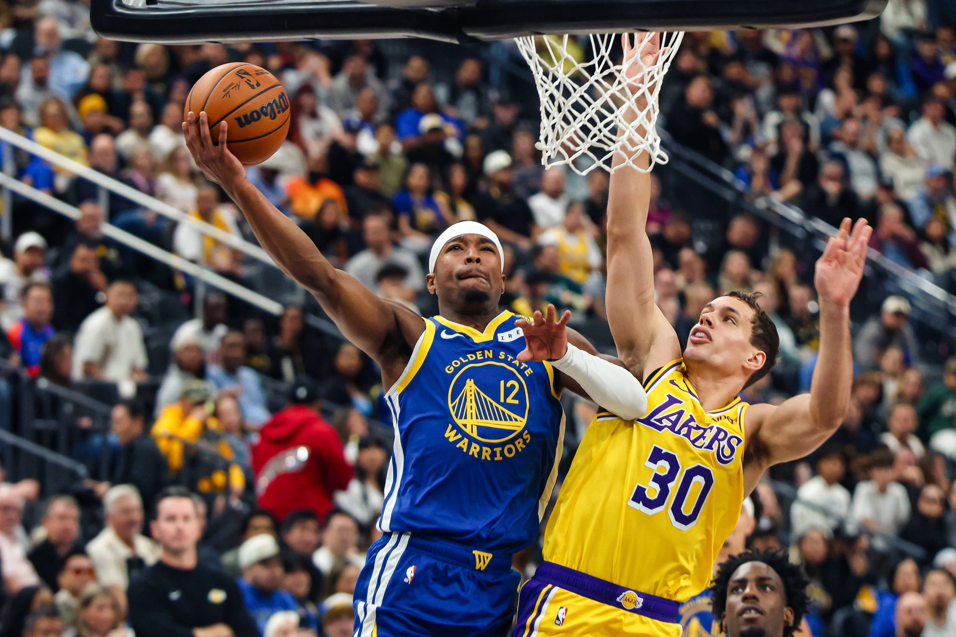 Brandon Williams attacks the rim against Chris Manon