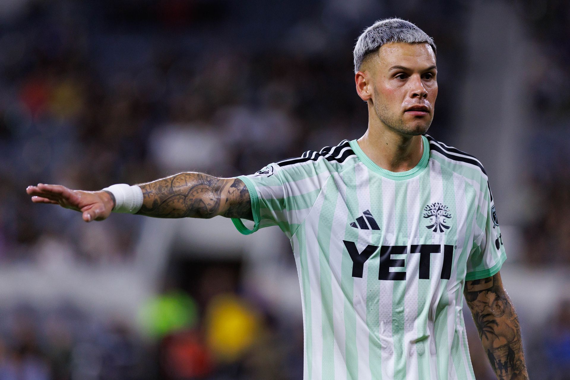 Christian Ramirez signals to his Austin FC teammates