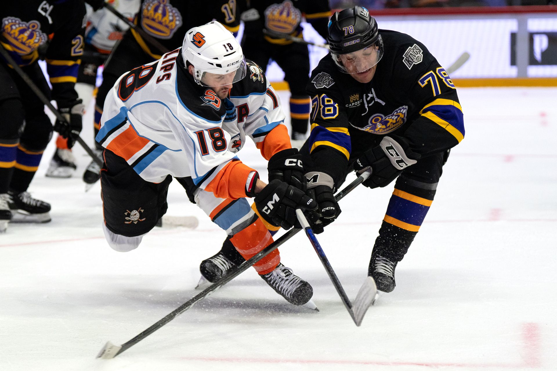 Matthew Phillips and Jared Wright battle for the puck