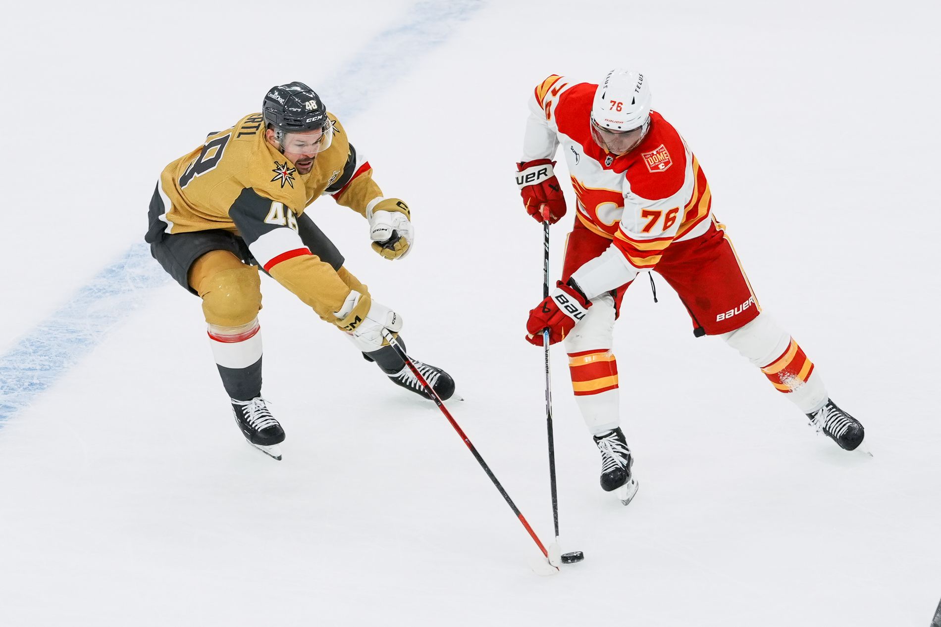 Tomas Hertl and Martin Pospisil reach for the puck