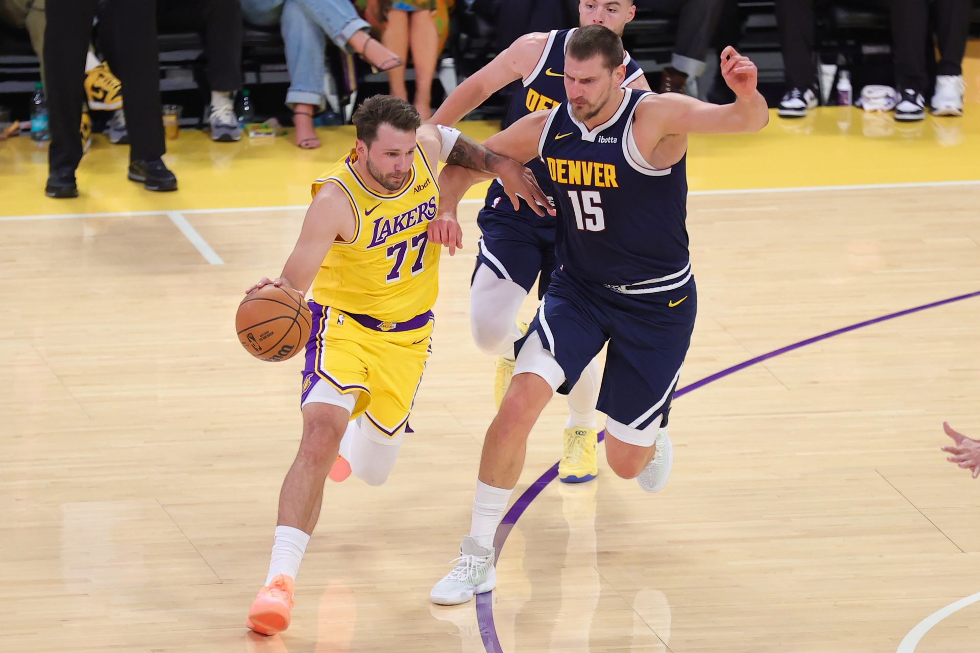 Luka Doncic drives against Nikola Jokic