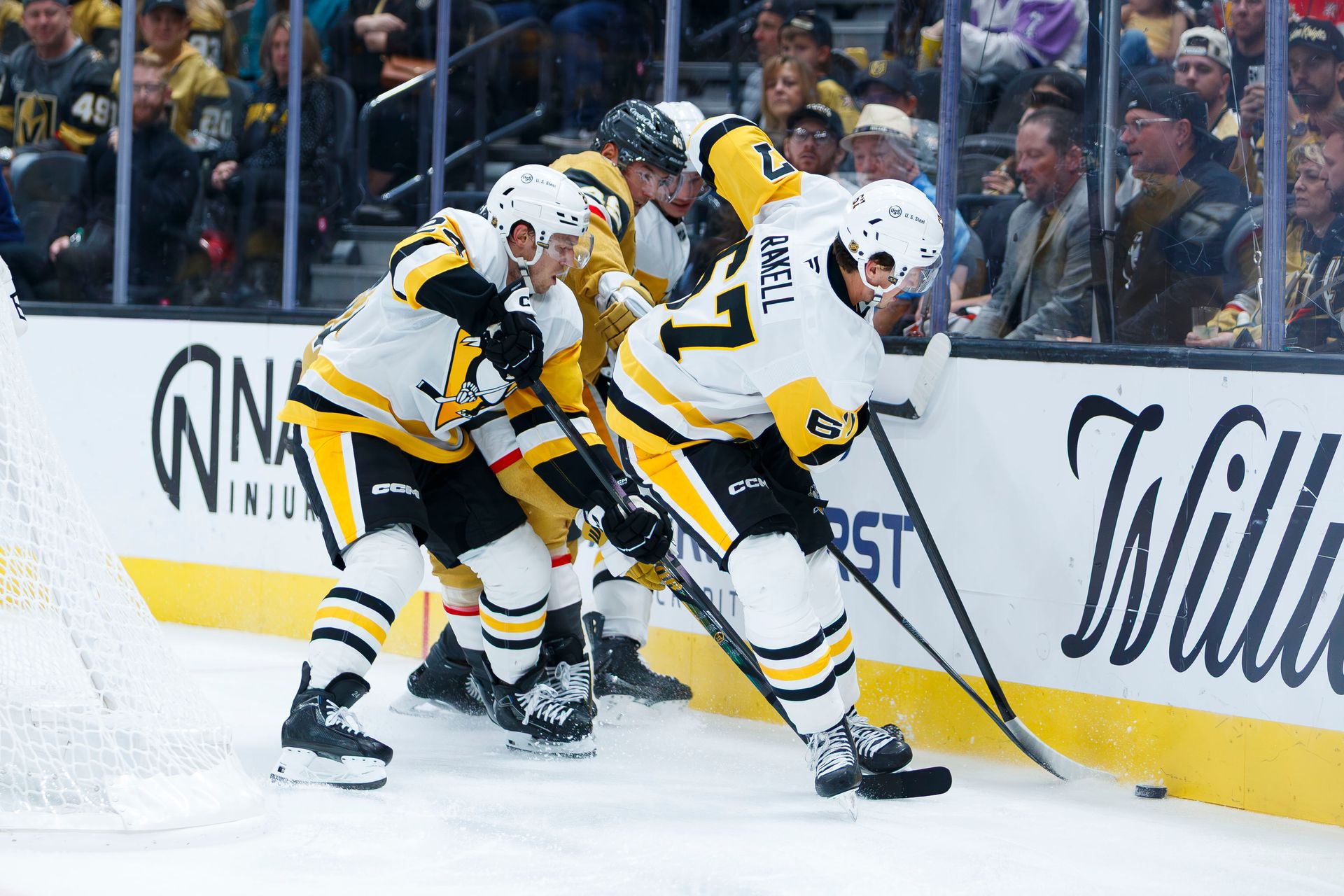Rickard Rakell battles for the puck behind the Vegas net