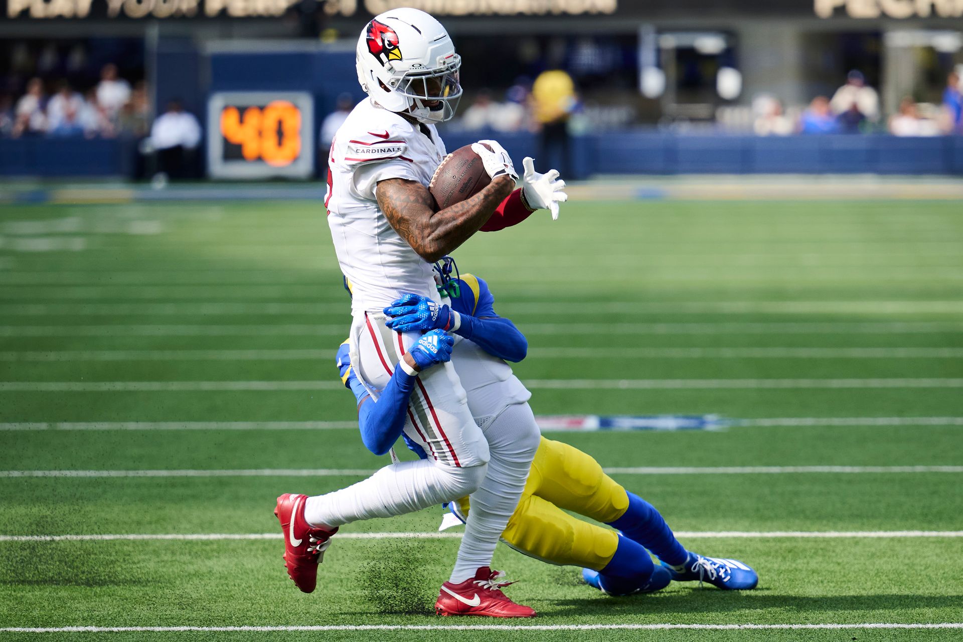 Emmanuel Forbes tackles a Cardinals player