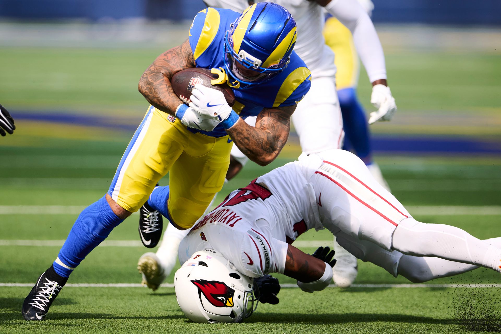 Blake Corum carries the ball against the Cardinals