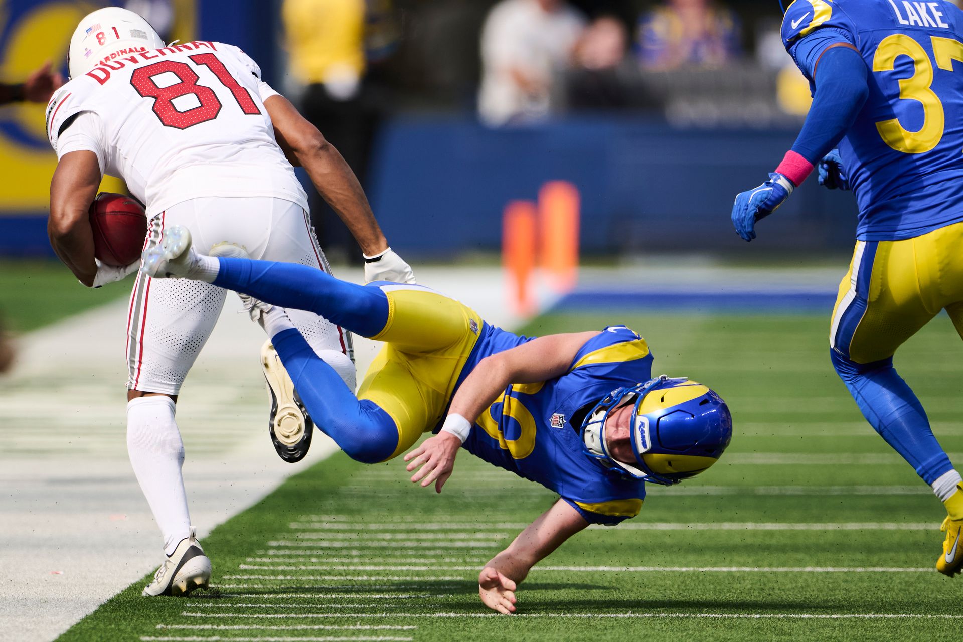Rams kicker Blake Grupe takes a hit against the Cardinals