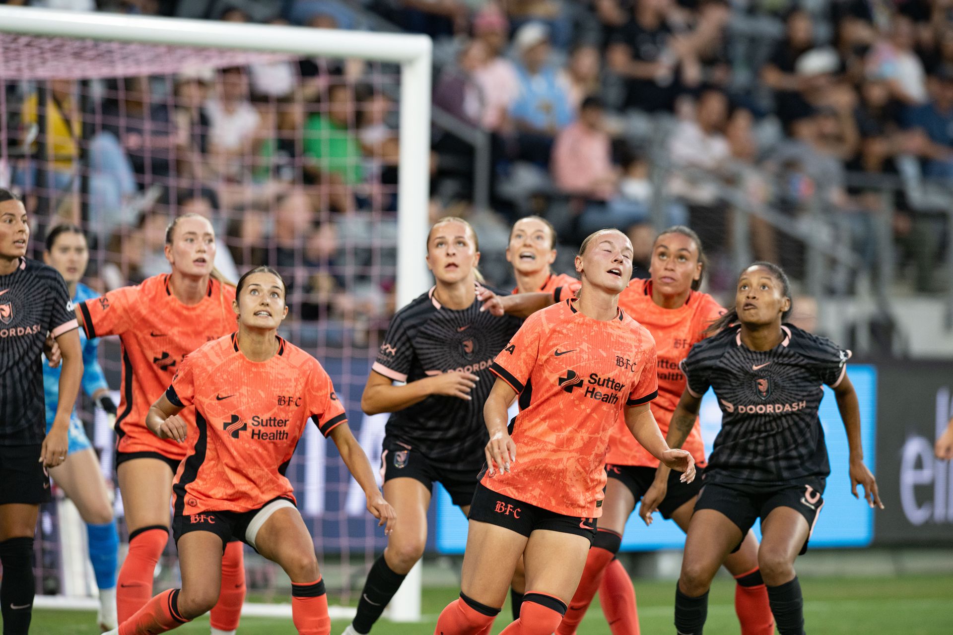Bay FC players battle for position on a corner kick