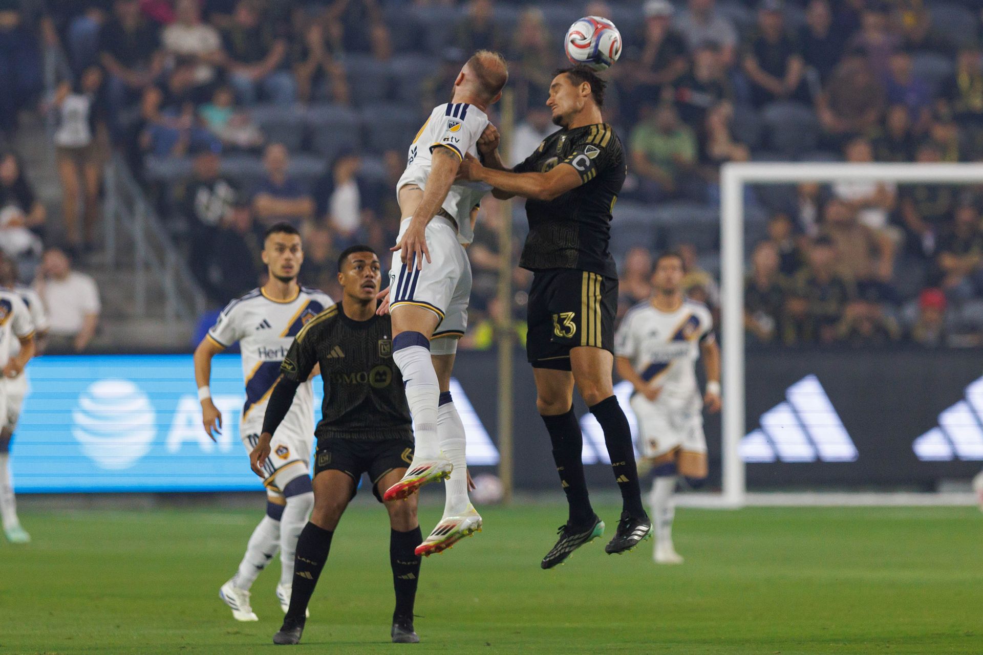 Aaron Long heads the ball against LA Galaxy