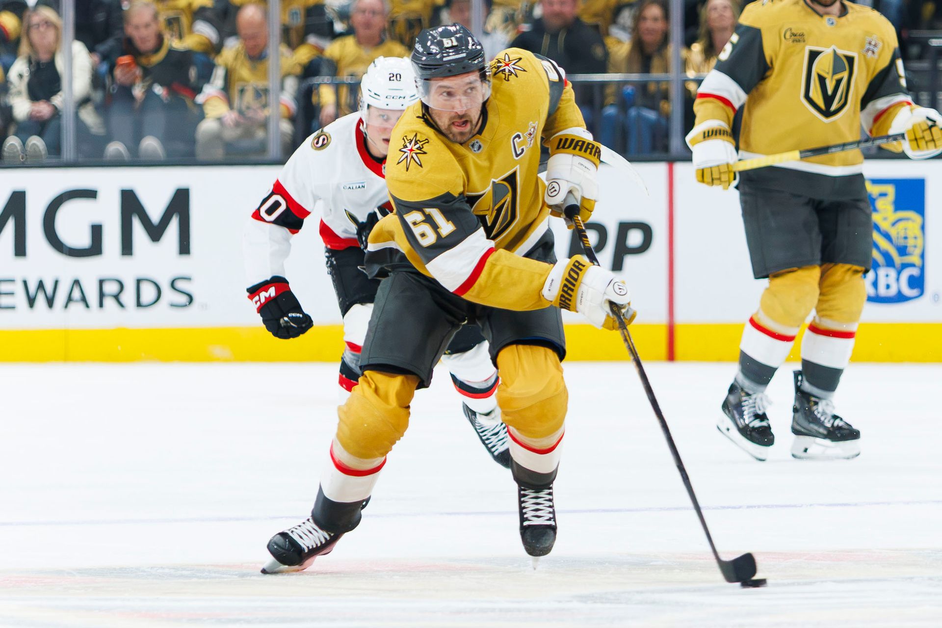 Mark Stone skates the puck down the ice against Ottawa