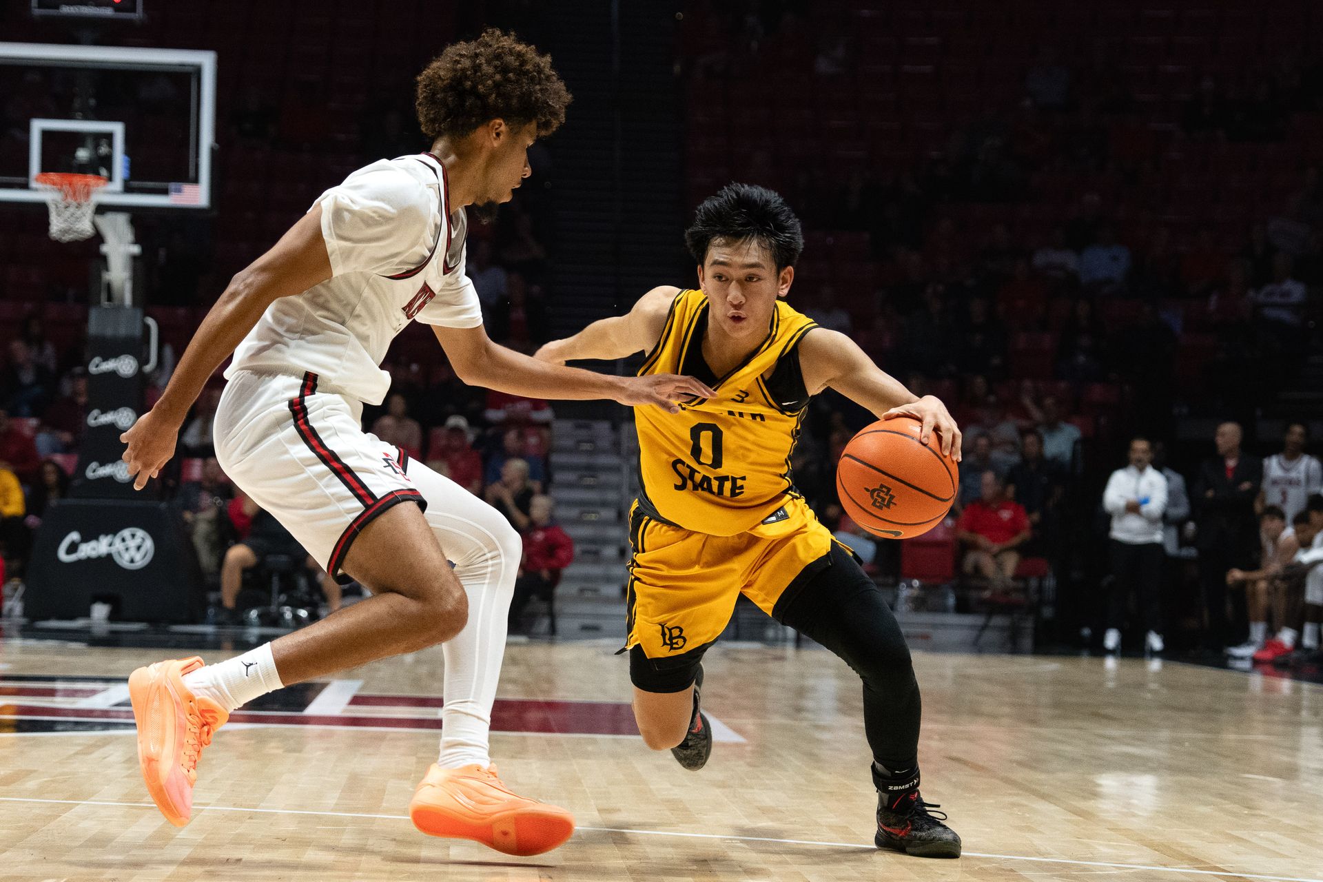 Long Beach State guard Jaden Tengan dribbles past defenders