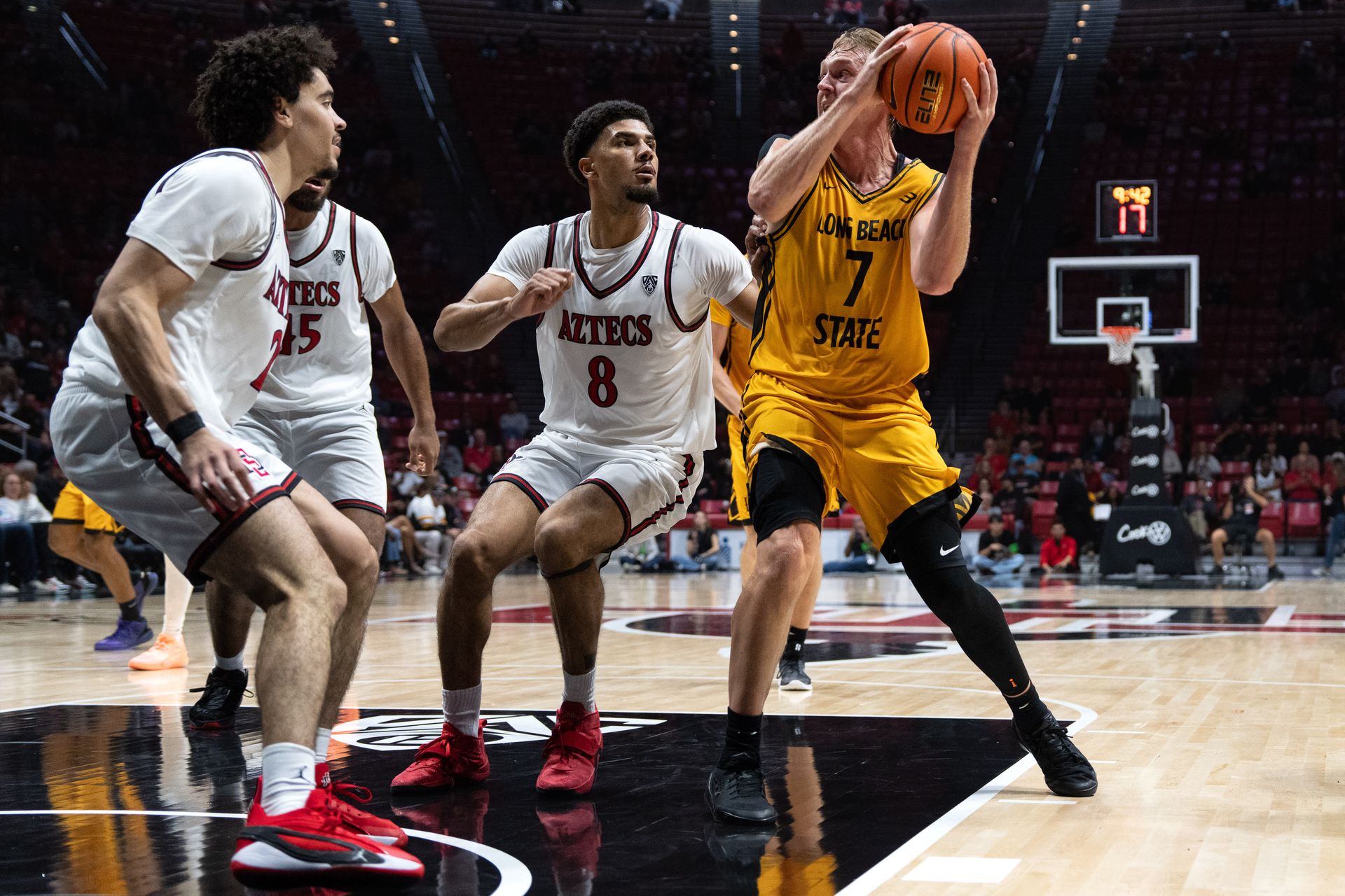 Long Beach State guard Jack Payne looks to pass