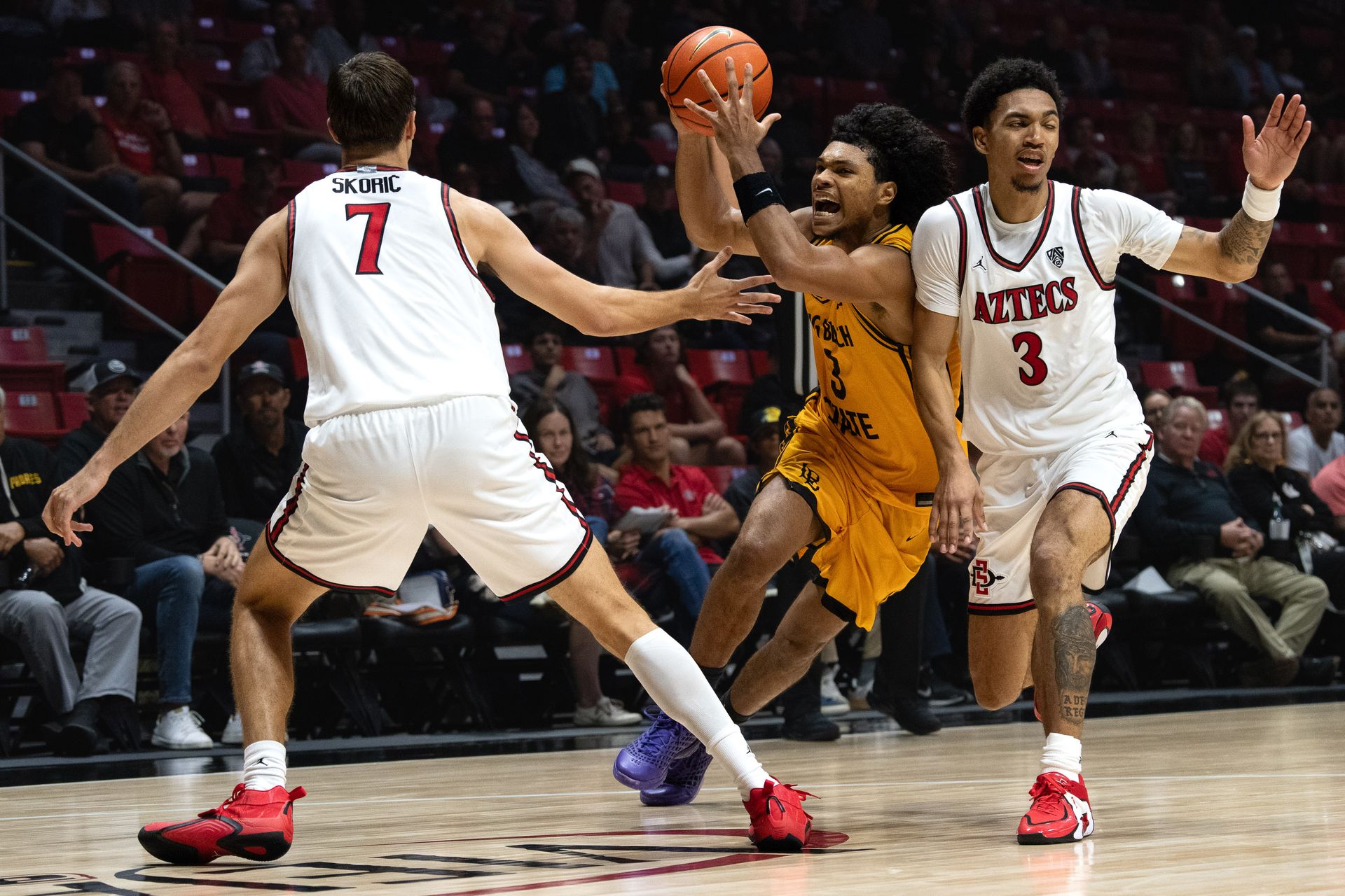 Long Beach State guard Yohann Sissoko draws a foul