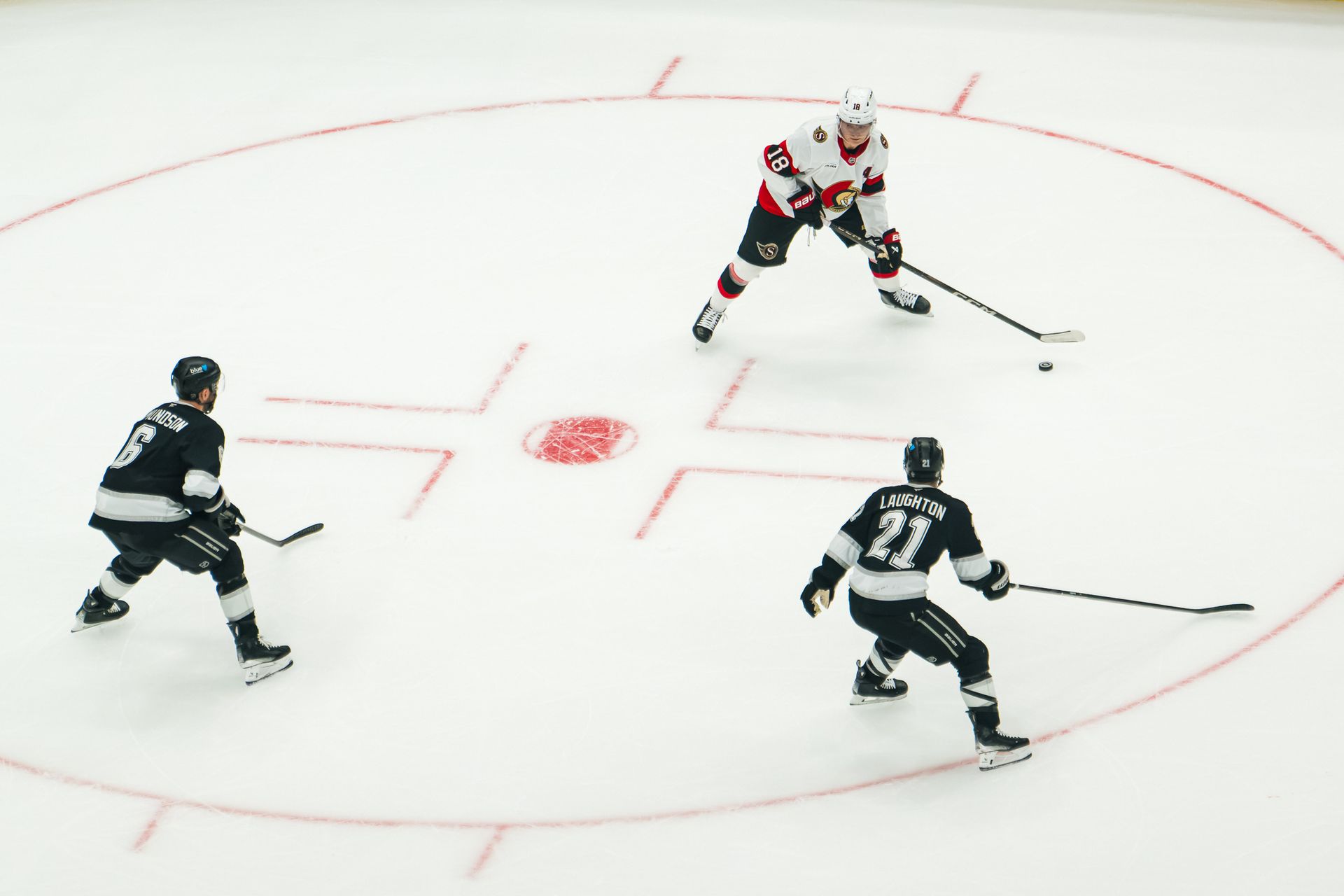 Kings converge on the puck against Ottawa