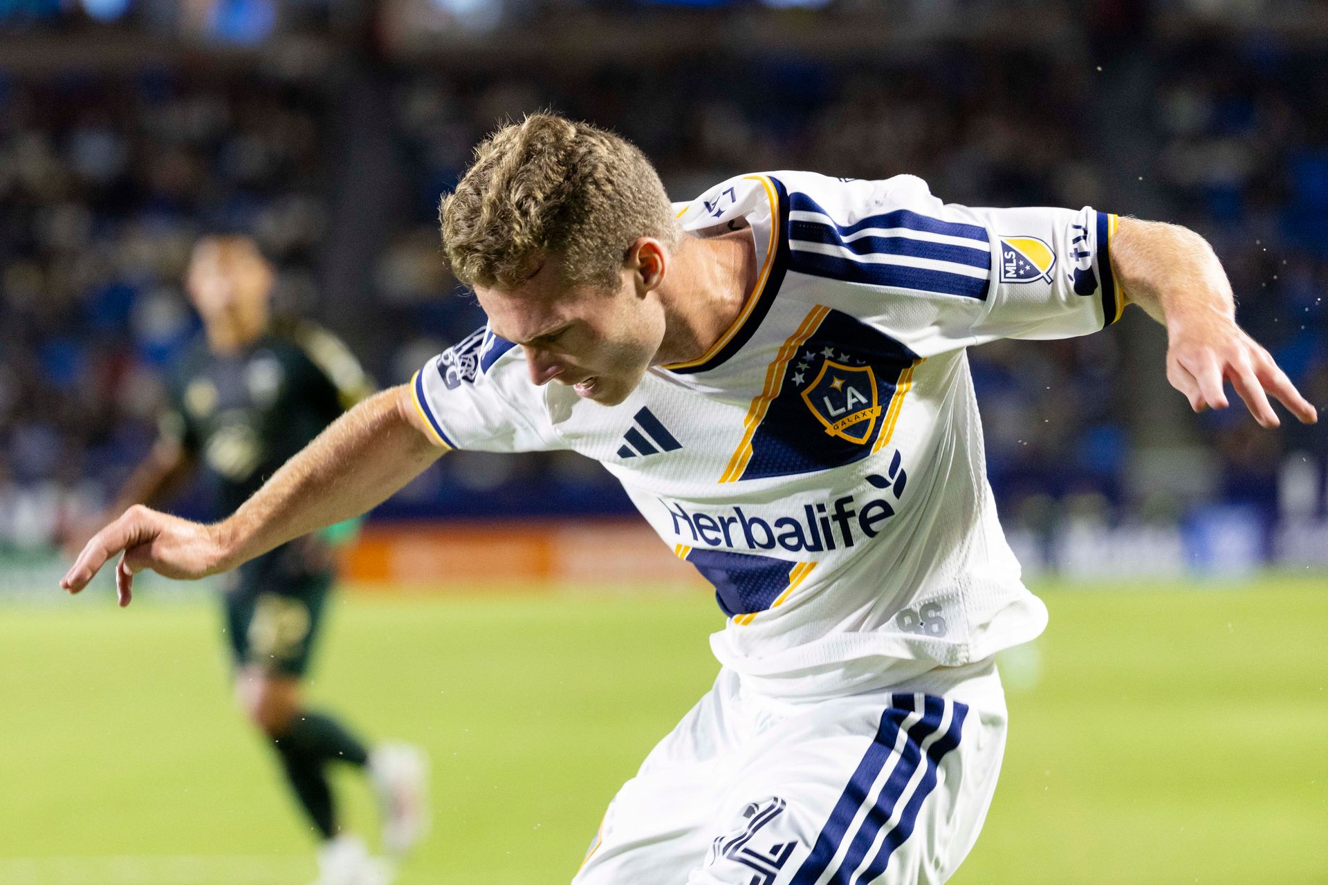 John Nelson runs with the ball against Portland